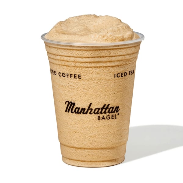 Manhattan Bagel's iced coffee or iced tea in a clear plastic cup with the logo.