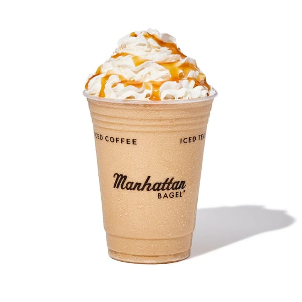 Manhattan Bagel's iced coffee drink topped with whipped cream and caramel drizzle.