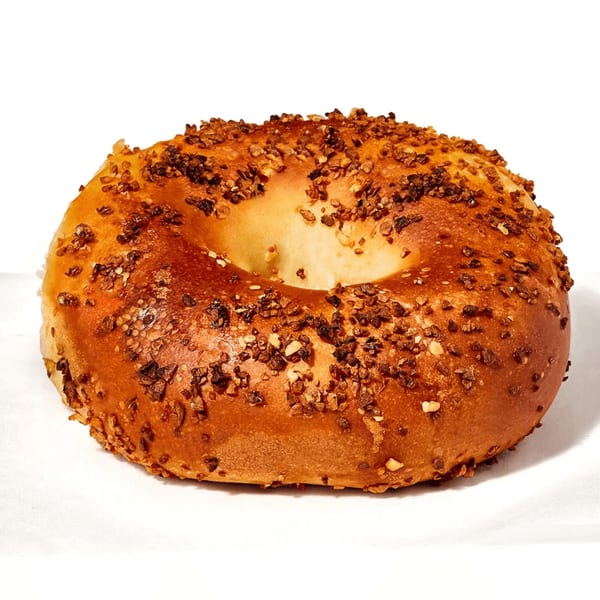 A Manhattan Bagel everything bagel, golden brown and covered in savory seasonings.