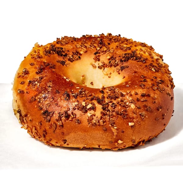 A golden-brown Manhattan Bagel with a generous topping of savory everything seasoning.